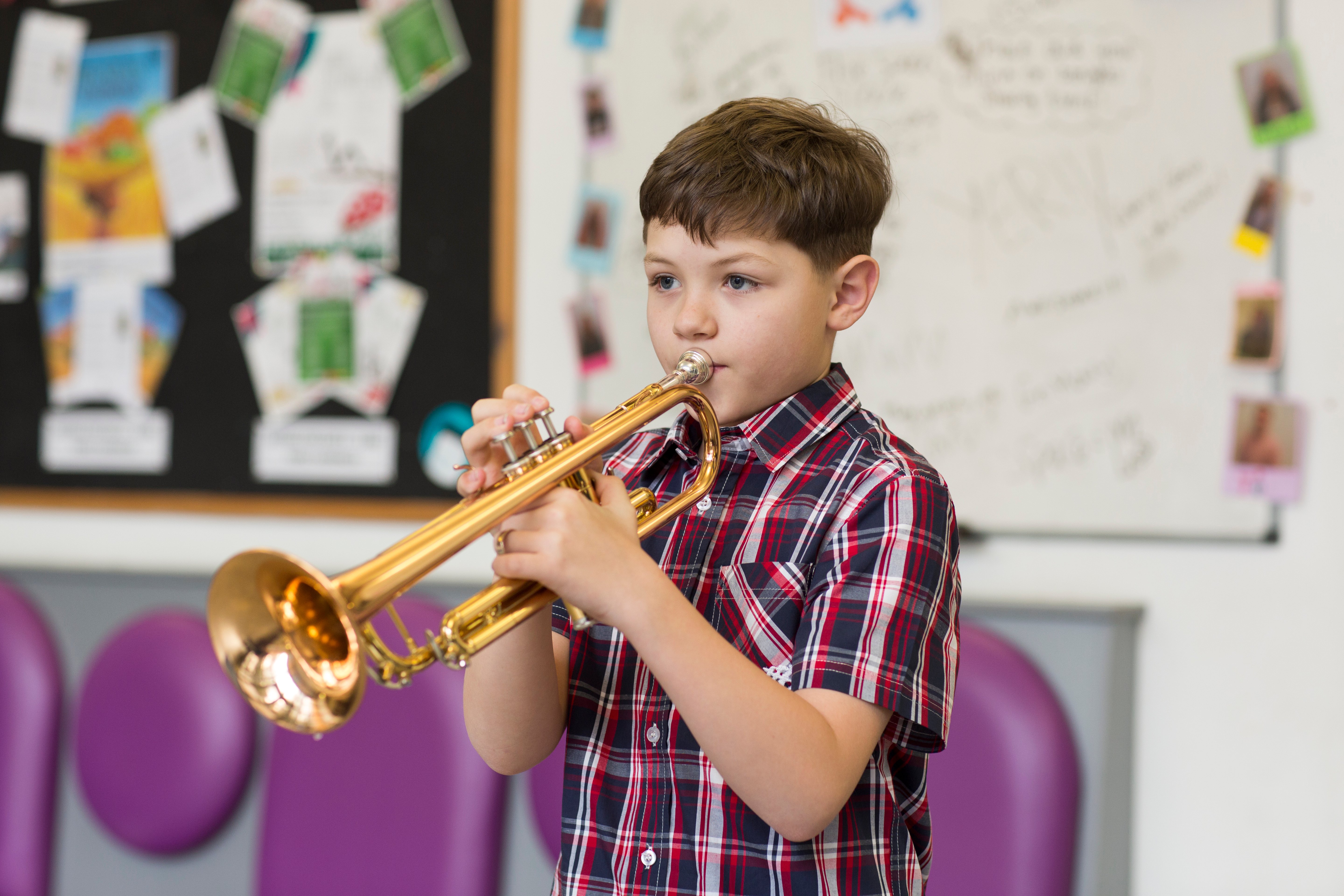 Little boy playing the trumpet