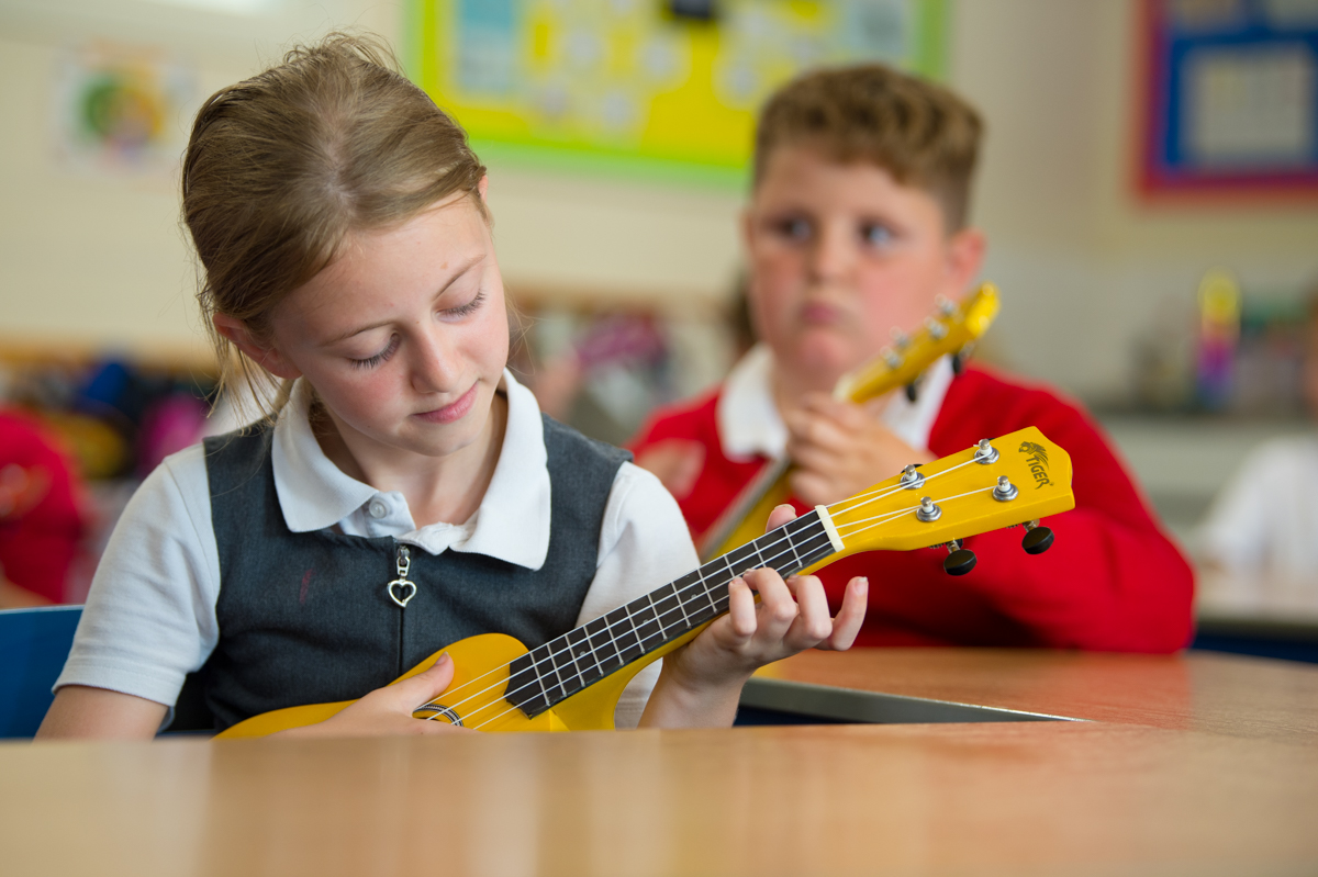 Children learning the ukulele